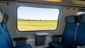 Train is going with empty seats and landscape can be seen on window Royalty Free Stock Photo