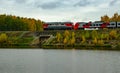 passenger train running over the dam along the river Royalty Free Stock Photo