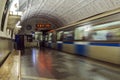 A train going into a subway tunnel is gaining speed.