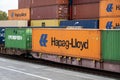 Train with Hapag-Lloyd and Evergreen container waggons in terminal Royalty Free Stock Photo