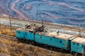 Train at the iron ore opencast mine is going for loading iron ore Royalty Free Stock Photo