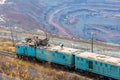 Train at the iron ore opencast mine is going for loading iron Royalty Free Stock Photo