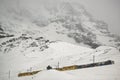 Train in Kleine Scheidegg under Eiger, Monch and Jungfrau peaks in Swiss Alps, Berner Oberland, Grindelwald,