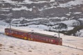 Train in Kleine Scheidegg under Eiger, Monch and Jungfrau peaks in Swiss Alps, Berner Oberland, Grindelwald,