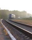 Train leaving the station on foggy morning. Industrial landscape Royalty Free Stock Photo