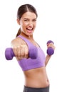 Train like a beast, look like a beauty. Studio portrait of a beautiful young woman lifting dumbbells.