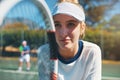 Train like a champion if you want to become one. an attractive young female tennis player outdoors on the court with her