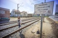 train line with informational traffic sign: walking on the line is prohibited.  Young woman walking Royalty Free Stock Photo