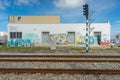 train lines seen in parallel with old building in the background