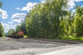 A train locomotive moving on the tracks heads towards an intersection in a mountain town in North Idaho, USA Royalty Free Stock Photo