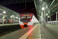 Train on Moscow passenger platform at night (Belorussky railway station) is one of the nine main railway stations in Moscow Royalty Free Stock Photo