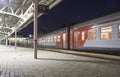 Train on Moscow passenger platform at night Belorussky railway station -- is one of the nine main railway stations in Moscow Royalty Free Stock Photo