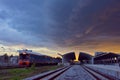 Train move out railway station on sunset Royalty Free Stock Photo