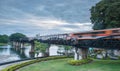 Train moving across River Kwai Bridge, Kanchanaburi, Thailand at