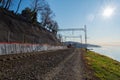 The train is moving along the railway line along the sea coast in the morning sun. Travel Royalty Free Stock Photo