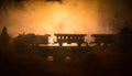 Train moving in fog. Ancient steam locomotive in night. Night train moving on railroad. toned foggy fire background. Horror mystic