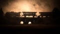 Train moving in fog. Ancient steam locomotive in night. Night train moving on railroad. toned foggy fire background. Horror mystic