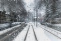 Train moving through a snowy neighbourhood