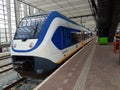 Train of the NS, dutch railways, sprinter is arriving along platform in Rotterdam Central Station, the Netherlands