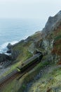 Train pass through railway track form mountain tunnel