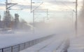 A train passed platform and left snow dust in the air