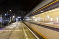 A train passes by at the train station in Sassenheim in the evening