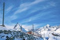 Red train passing through snowy Matterhorn mountain against sky during winter Royalty Free Stock Photo