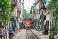 Train passing narrow road in old town in Hanoi