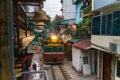 Train passing narrow road in old town in Hanoi