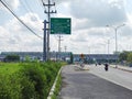 When the train passing over the traffic lights at the Adi Soemarmo Airport intersection Royalty Free Stock Photo