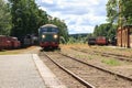 A train pulling into the old train station on the lake shore in Nora Sweden Royalty Free Stock Photo