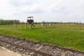 Train rail, watch tower and the ruins of the old barracks from Birkenau