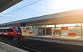 Train on the railroad tracks during sunset. Perron at the train station. Royalty Free Stock Photo