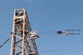 Train or railway power line support. Railway power lines with high voltage electricity on metal poles against blue sky. Royalty Free Stock Photo