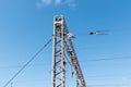 Train or railway power line support. Railway power lines with high voltage electricity on metal poles against blue sky. Royalty Free Stock Photo