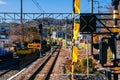 Train railway tracks junction with traffic light signal and engineer worker on inspection duty