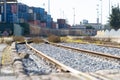Train railways near the warehouse with a bunch of containers in the open air