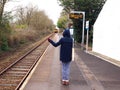 Train request stop - girl signalling to driver to stop train