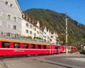 Train of the Rhaetian Railway passing along a street in the city of Chur, Switzerland