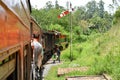 Train ride in Sri Lanka. Man hanging on a wagon. Kandy / Sri Lanka - 12.03.2018 Royalty Free Stock Photo