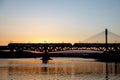 The train riding over the bridge over the river at sunset. Royalty Free Stock Photo