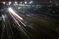 The train rushes on the rails at night.