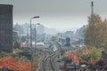 Train station is being renovated, trains stopped at a station and a closed train track with freshly built rails and sleepers is