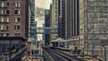 Train Station on Elevated tracks within buildings at the Loop, Glass and Steel bridge between buildings Chicago City Center - Dar Royalty Free Stock Photo