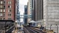 Train Station on Elevated tracks within buildings at the Loop, Glass and Steel bridge between buildings Chicago City Center