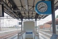 Train station, italy - summer 2020: a big blue clock over the binary near the exit in train station
