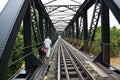 Man crossing a steel railway bridge
