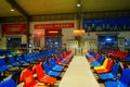 Train station passenger waiting area, rows of chairs and a number of male and female passengers