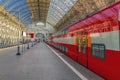 Train station with red cars of the railway express. Sunny Travel concept. Royalty Free Stock Photo