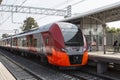 Train Swallow arrives at the passenger platform station Botanical Garden of the Moscow central ring Royalty Free Stock Photo